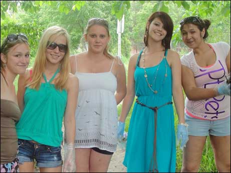 On a sunny day, a group of five Youville Centre Students Celebrate Earth Day.