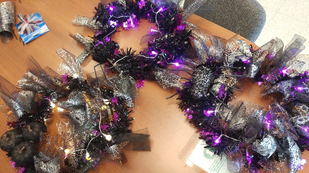 Photo of 3 halloween themed wreaths on a table made at the Alumnae Cafe October 2022